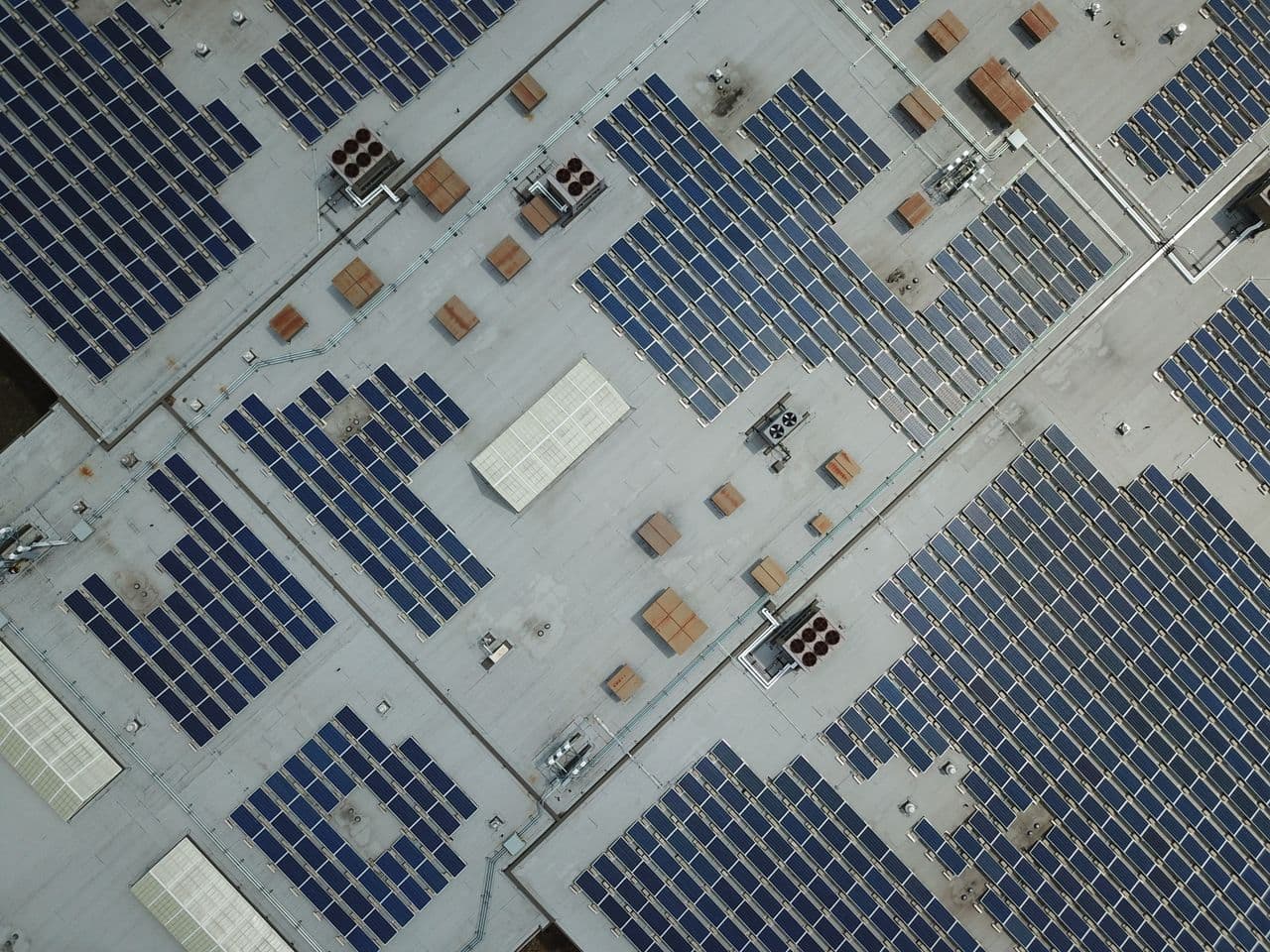 Aerial view of solar arrays covering a large commercial rooftop